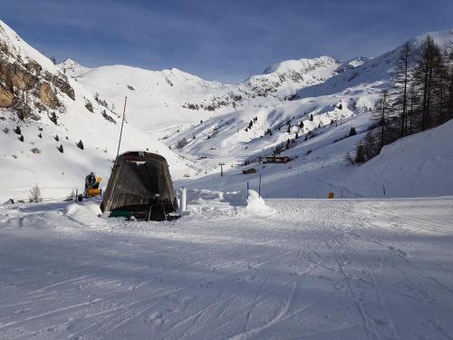 a snow covered mountain with a tent in the snow at Hotel Pedretti in Branzi