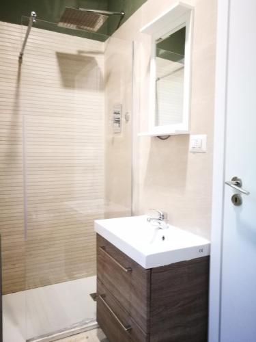 a bathroom with a sink and a shower at La Caravella apartament in Rapallo