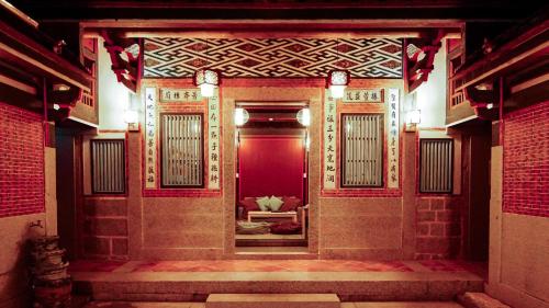 an entrance to a building with a red door at Beishan Old Western Style Hostel in Jinning