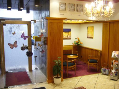 a waiting room with a table and a butterfly wall at Hotel Alter Kranen in Würzburg