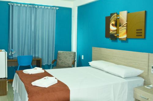 A bed or beds in a room at Bonjour Hotel