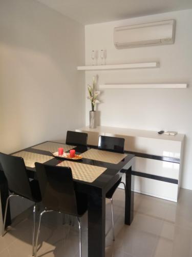 a dining room with a table and chairs at Mosaic Condminum A24m by malai in Mae Pim