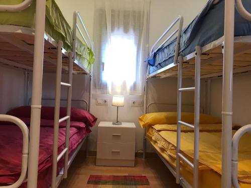 two bunk beds in a room with a window at La Caseta del Montsec in Àger