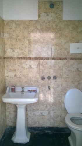 a bathroom with a sink and a toilet at La Casa de Pichona in Miramar