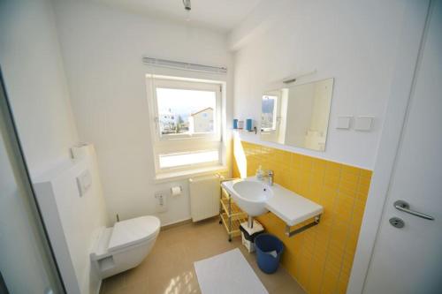 a bathroom with a white toilet and a sink at Rubeši in Kastav