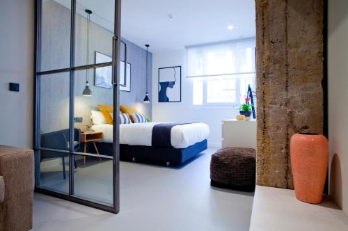 a bedroom with a bed and a large mirror at Bilbao Centric Apartments in Bilbao