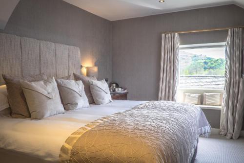 a bedroom with a large bed and a window at The Grand at Grasmere in Grasmere
