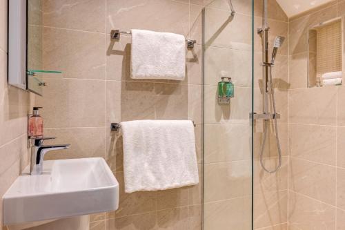 a bathroom with a sink and a shower at The Grand at Grasmere in Grasmere