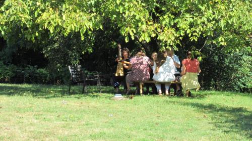 a group of people sitting on a bench under a tree at Panorama B&B in Ptuj