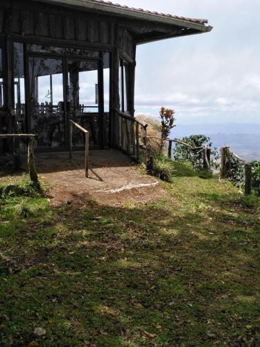 a building on the side of a hill with a view at Cabañas Don Camilo Albergue de Montaña in Cabecera de Cañas