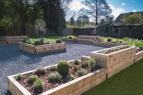 a garden with four raised beds with plants at The Grand at Grasmere in Grasmere