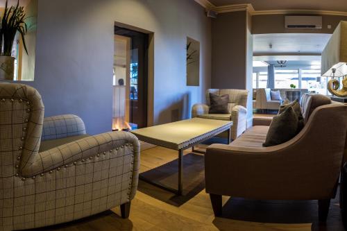 a living room with two chairs and a table at The Grand at Grasmere in Grasmere