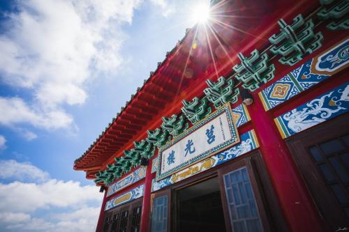 a building with a sign on the side of it at Beishan Old Western Style Hostel in Jinning