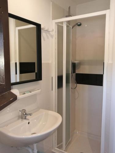 a bathroom with a sink and a shower with a mirror at IRON GATE MARINA3B in Sarzana