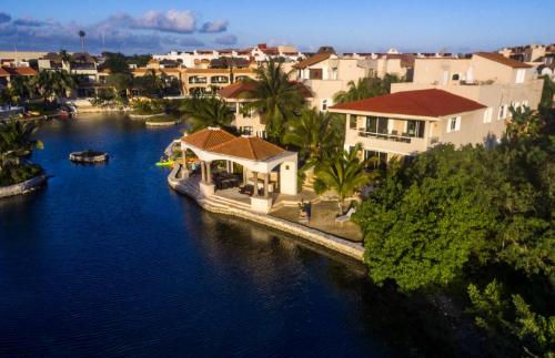an aerial view of a river with houses and a boat at Condo Bellmare in Puerto Aventuras
