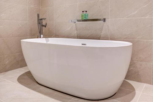 a white bath tub sitting in a bathroom at The Grand at Grasmere in Grasmere