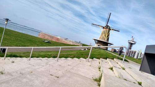 a windmill sitting on top of a hill with stairs at Bellevue Boulevard 32 in Vlissingen