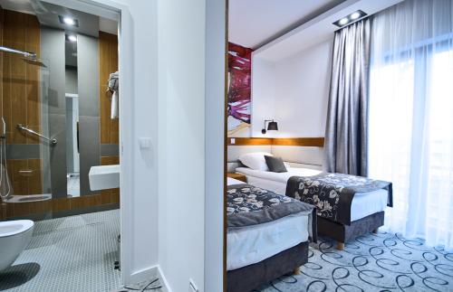 A bed or beds in a room at Hotel Kozak