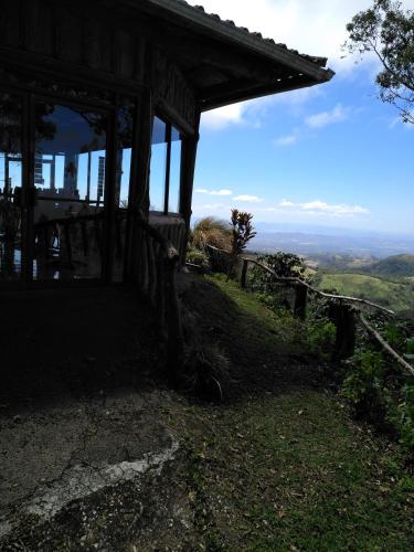 a cabin on top of a hill with a view at Cabañas Don Camilo Albergue de Montaña in Cabecera de Cañas