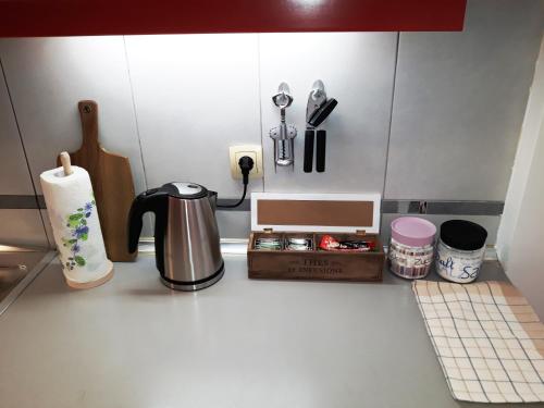 a kitchen counter with a coffee pot and a box at Maritimo Apartments in Kotor