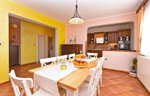a kitchen and dining room with a table and chairs at Apartment Modrusani 1561 in Žminj