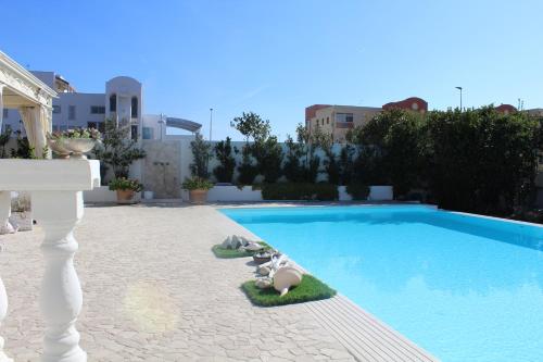 a swimming pool with some animals laying next to it at White House Luxury Hospitality in Olbia