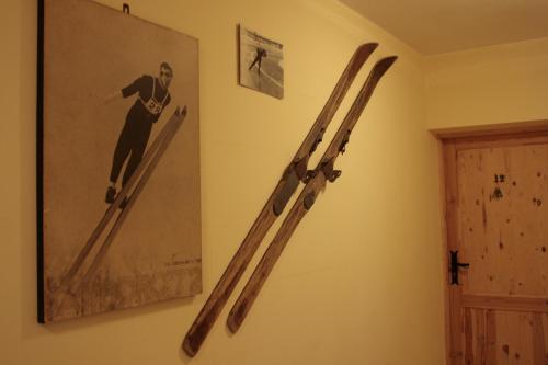 a pair of skis on a wall next to a picture at Gościniec i Herbaciarnia Pod Złotą Łyżwą in Białka Tatrzanska