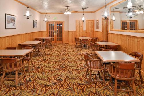 a dining room with wooden tables and chairs at Stage Coach Inn in West Yellowstone