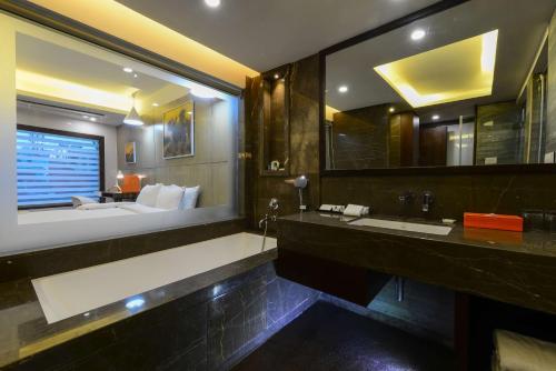 a bathroom with two sinks and a large mirror at Howard Johnson by Wyndham, Kolkata Airport in Kolkata