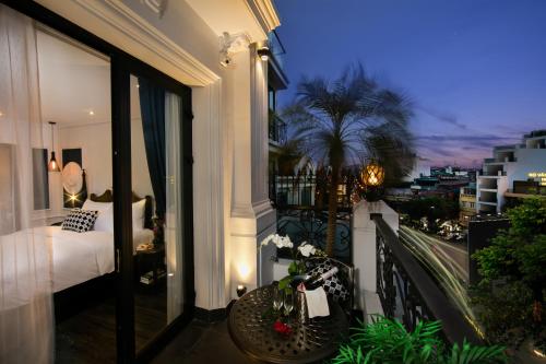 a balcony with a bed and a view of a city at JM Marvel Hotel & Spa in Hanoi