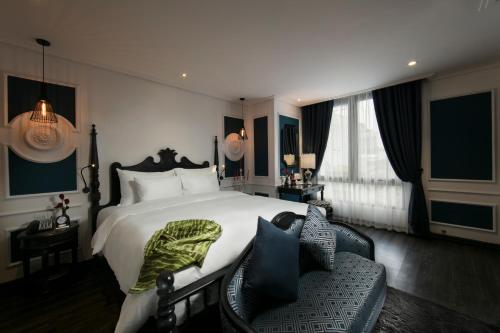 a bedroom with a large bed and a couch at JM Marvel Hotel & Spa in Hanoi