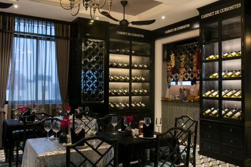 a dining room with tables and chairs and wine racks at JM Marvel Hotel & Spa in Hanoi