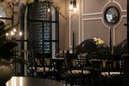 a room with tables and chairs and a mirror at JM Marvel Hotel & Spa in Hanoi