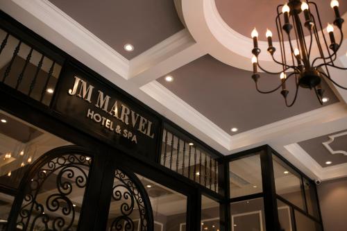 a chandelier and a sign in a store at JM Marvel Hotel & Spa in Hanoi