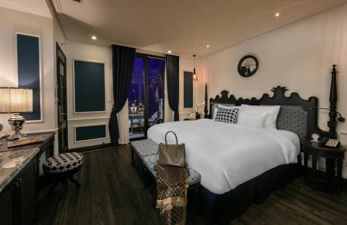 a bedroom with a large white bed and a window at JM Marvel Hotel & Spa in Hanoi