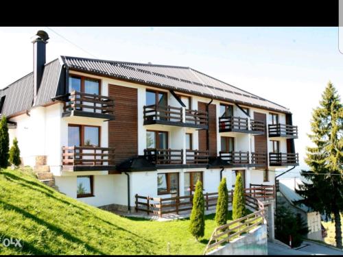 a large house with balconies on a hill at Vlašićka priča Eko Fis in Vlasic