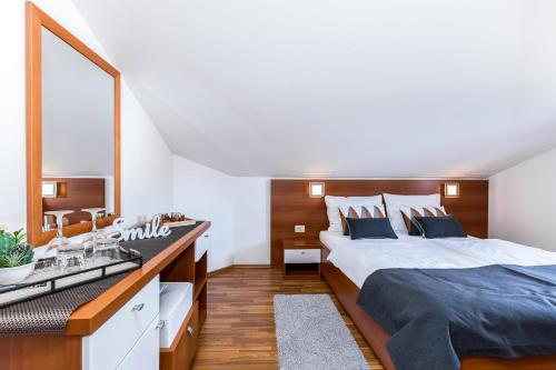 a bedroom with a large bed and a sink at Villa Nada in Lovran