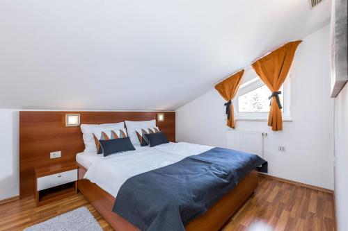 a bedroom with a large bed and a window at Villa Nada in Lovran