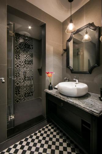 a bathroom with a sink and a shower at JM Marvel Hotel & Spa in Hanoi