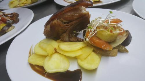 a plate of food with meat and potatoes on a table at Alto Verde Suite & Apart in Termas de Río Hondo