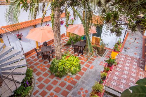 an overhead view of a patio with tables and umbrellas at Hostal Riviera Sucre in Otavalo