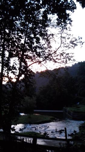 a view of a river with a fence and trees at Recinto Natural SEMUK in Zacatlán