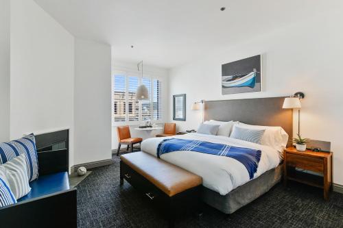 a hotel room with a bed and a chair at Waters Edge in Tiburon