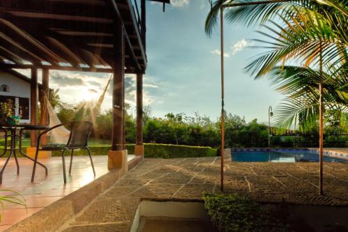 a patio with a table and chairs next to a pool at Casa Bari La Antigua in Barichara