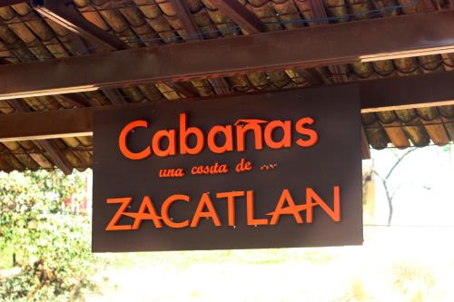 a sign for a zacián restaurant hanging from a roof at Hotel y Cabañas una Cosita de Zacatlán in Zacatlán