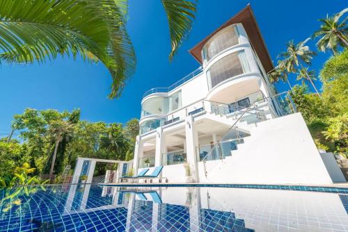 an exterior view of a house with a swimming pool at White Stone - Luxurious Sunset View 4 Bed Pool Villa in Nathon