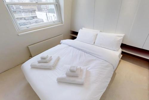 Un ou plusieurs lits dans un hébergement de l'établissement Comfortable Aircon Apartment Earls Court