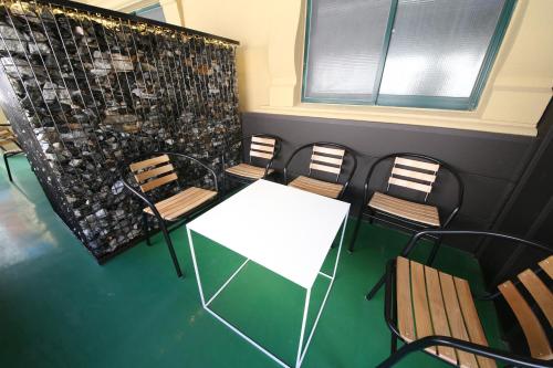 a conference room with a white table and chairs at Soho Hotel in Busan