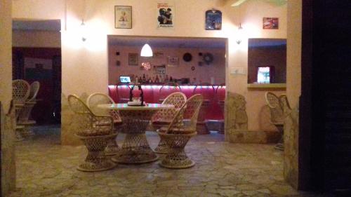 a restaurant with a table and chairs in a room at Casa Picadilly in Boca Chica