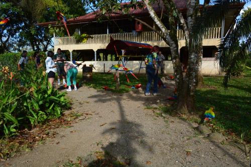 a group of people standing in front of a house at Finca Dos Calaveras in Ángeles